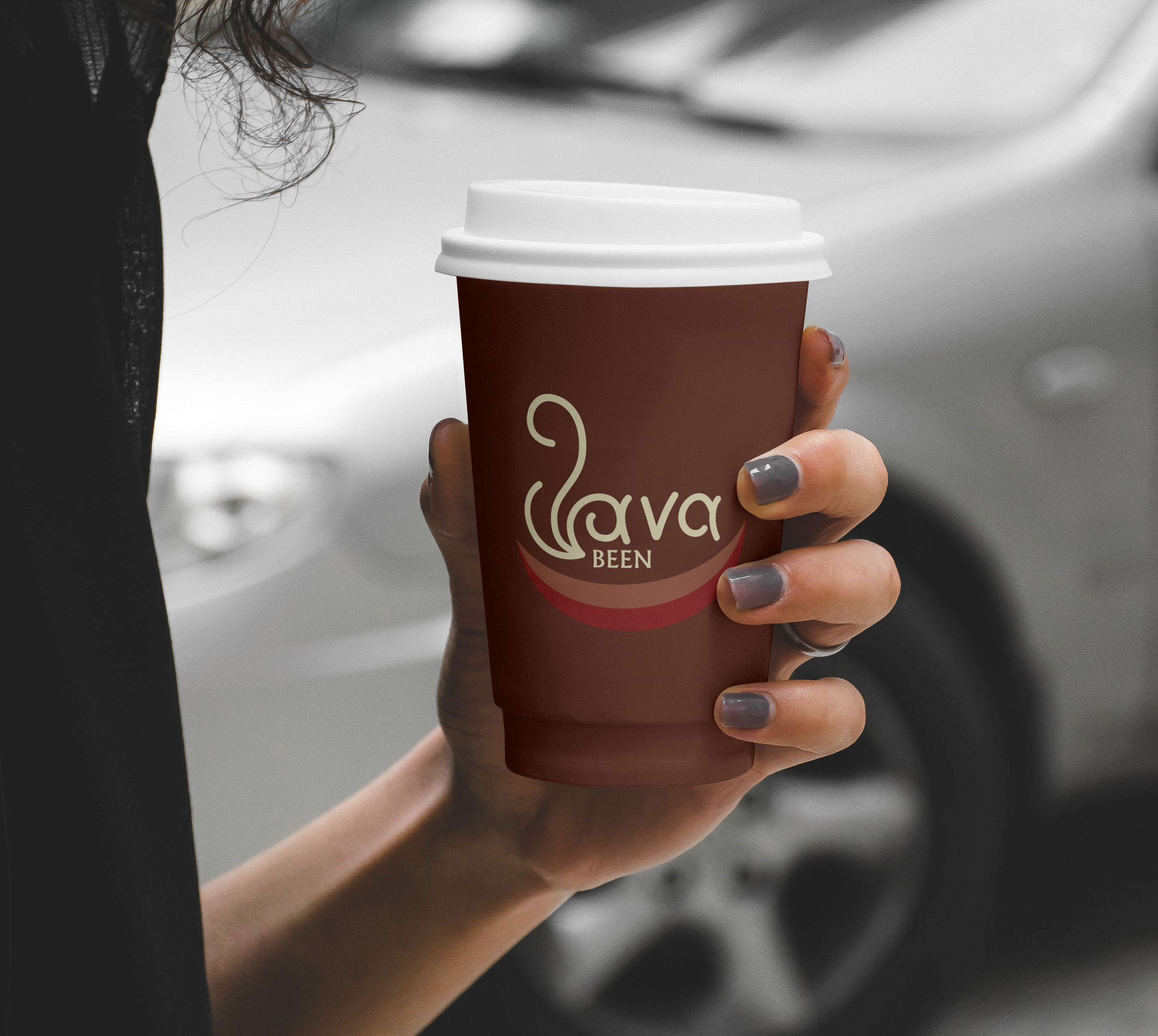 woman holding coffee cup on street