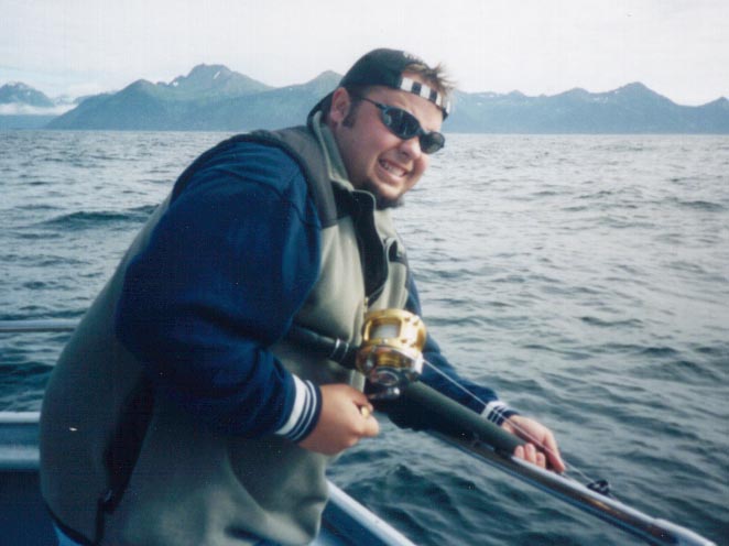 Michael smiles/grimaces while reeling one in