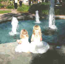 Wedding flower girls, Clay's nieces, Hannah and Alyssa enjoying the fountain in the park, prior to the wedding. Daughters of his older sister, Stacy, who passed away October 7, 2003, they adore 'Unca Clay'.