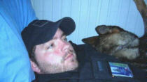 Scott and his dog, taking a well deserved break,after searching for explosive devices, somewhere in the Middle East.