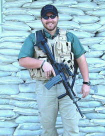Melinda's brother Scott, posing in front of a sandbag wall, somewhere in the Middle East, 2006.