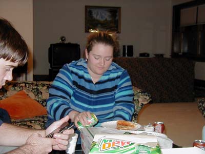 Candid shot, as she pours her drink at and gets ready to grab some food.