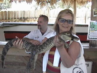 Jean gets to hold the baby alligator-- she says it is soft.