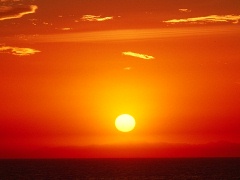 Enjoy the sun setting whil'st you have a drink in a beach bar.