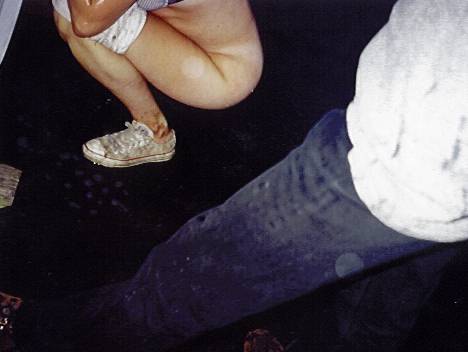 girl pissing behind the port-o-potties