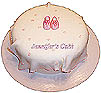 There are handmade baby booties on top of a very thin layer of fondant&nbsp; handkerchief