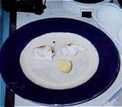 Pre-warmed tortilla coated with charred egg whites and recovered egg yolk bolus.