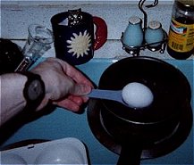Add the egg to boiling water. Observe all safety rules.