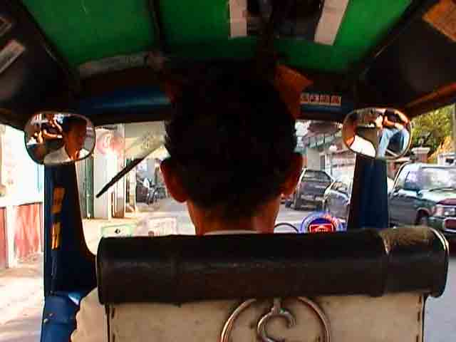 back of a tuktuk driver. i swear they all have formala one training.