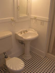 Attractive pedestal sink with well-lit medicine cabinet