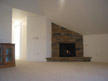 View of living room entrance, fireplace, and built-in bookcase
