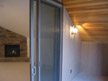 View of living room from tiled porch