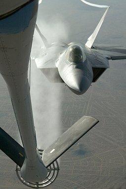 A modified KC-135 Stratotanker sprays water on a F/A-22 during an airborne ice test here Jan. 26 and 28. (Photo by Derk Blanset)
