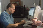 [photo of jim writing his diary monitored by his mentor priscilla]