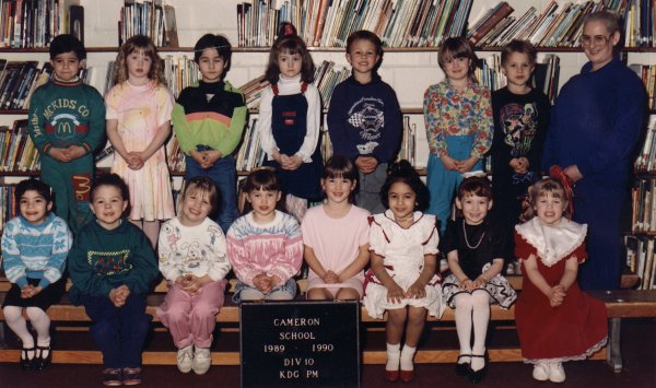 My class picture in Kindergarten...I am the one with the short brown hair looking very miserable in the top row in between the 2 boys...see me?