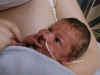 Cute little Nate enjoying his fingers during kangaroo care time  (54575 bytes)