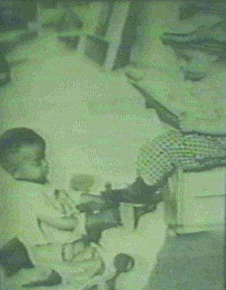 Black boy shining white boy's shoe_his job