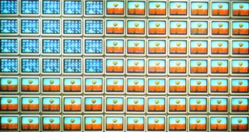 Video Flag Y (1985), by Nam Jun Paik. 84 TV sets, 3 video disk players, 8 electric fans, plastic frame
74.5 x 138.5 in.