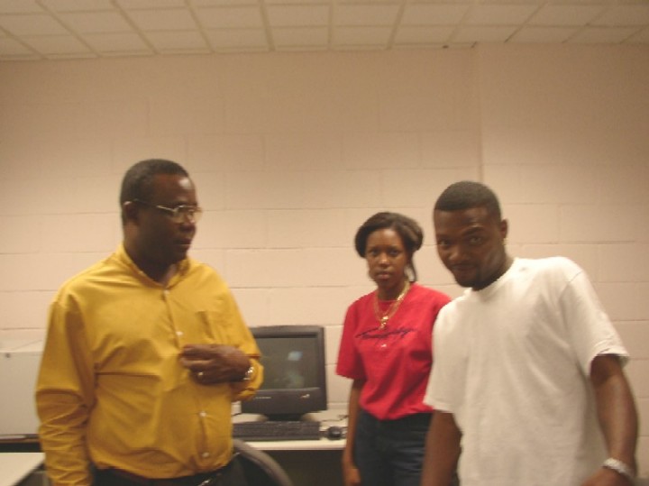 Dr. Mube talking with Leshun while N'eleen looks on