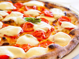 A margherita pizza with mozzarella, baby tomatoes and oregano.