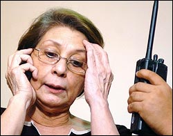 Ninez Cacho-Olivarez, editor in chief of a pro-opposition newspaper, The Daily Tribune, talks on her phone in her office after government announced it was taking over the publication temporarily. -photo: PDI