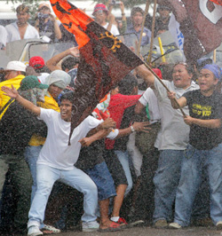 Protesters clash with riot police as Pres. Arroyo rovoked all rally permits. A State of Emergency was delared as the nation commemorates People Power I.