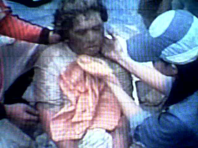 a survivor is comforted by rescue workers
