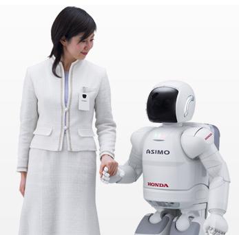 picture of ASIMO and  a woman holding hands together.
