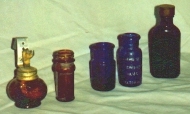 one on left is a lamp oil bottle with wick
