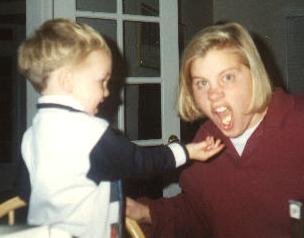 Fall 1993, our little cousin Richard Fetzer takes his turn feeding Sara her Cheerios.  (She won't eat unless you fly it in like an airplane.)