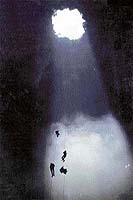 Speleologists rappeling into Las Golondrinas