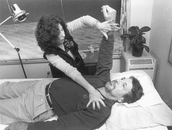 Reflexologist/acupuncturist Stephanie Di Pietro performs applied kinesiology on debunker Andrew Neher - photo Robert Scheer