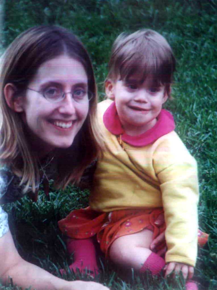 Julie and Brit resting on the grass at the zoo