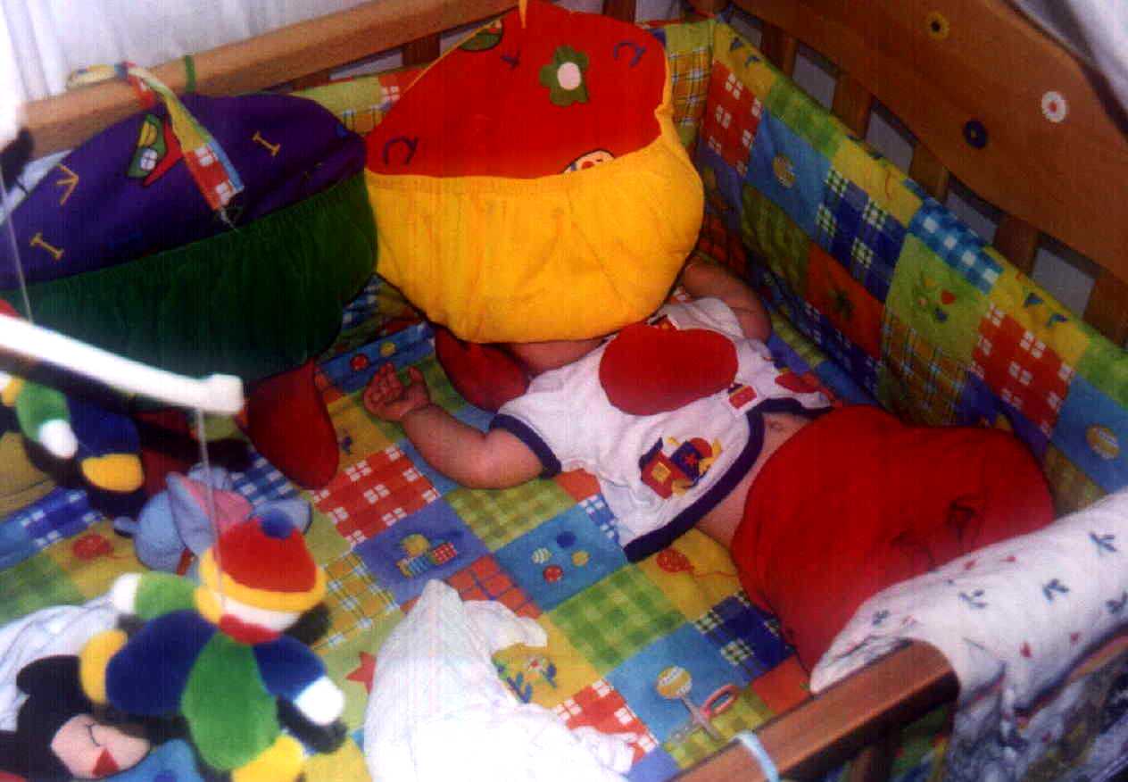 Brit sleeping with the crib actviity center on her head