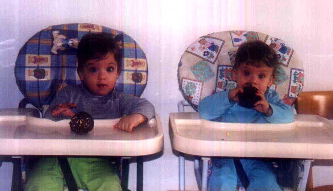 Brit and Zach on their first birthday - having birthday cupcakes