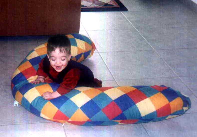Zach scooting along with the nursing pillow