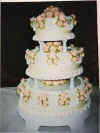 Peach roses on an ivory cake