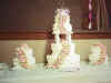 Pink frosting flowers on 3 stacked cakes