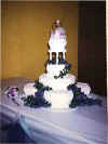 Purple frosting flowers on a stacked cake