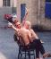 Paul naked behind a bald guy