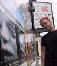 Paul next to a Mutter poster