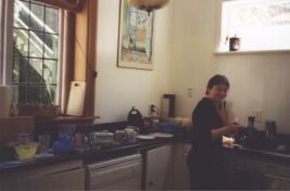 Manda cooking bacon and eggs in the kitchen