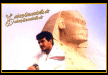 Ajith in front of statue