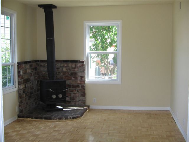 The woodstove will eventually be replaced by a soapstone stove & the brick on the wall removed