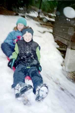 kids sledding out the back yard