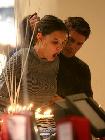 Tom Cruise gives fianc&eacute;e Katie Holmes a hand as she blows out her birthday candles at FAO Schwarz on Thursday. The New York City toy store opened after-hours for her surprise 27th-birthday party.