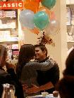 After sharing a smooch, the twosome, along with his mom, 12-year-old daughter Isabella and Holmes's parents, celebrated in the store's cafe, where bunches of balloons floated atop stuffed white tigers and giraffes.