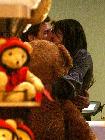 Cruise and Holmes steal a kiss and share a three-way hug with an oversized stuffed bear after checking out the store's most famous toy: a floor piano. And like Tom Hanks's Big character, Cruise ran atop the keyboard, adding his own move: a handstand.