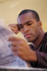 Man reading newspaper--source:http://www.micron.com
