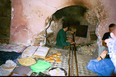 Women prepare the bread and bring it to this bakery